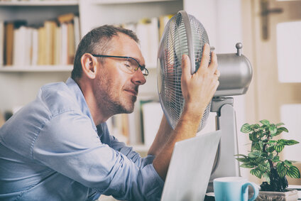 Man in front of fan